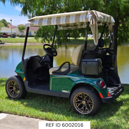 Side angle of 2027 E-Z-GO RXV2 Elite in green parked near palm trees in South Florida
